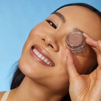 model wearing and holding one of the neutral shades