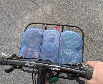 A reviewer with the case strapped to a basket on their bicycle for easy transport 