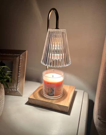 reviewer photo of the lit lamp on a nightstand