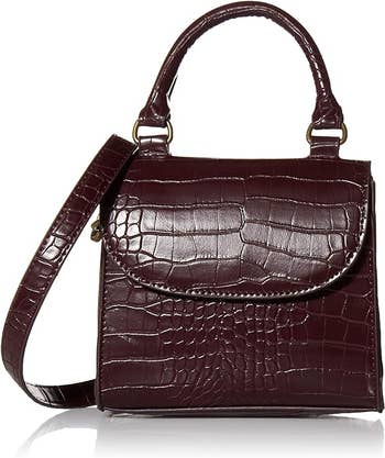 Handbag with crocodile texture, flap closure, and top handle