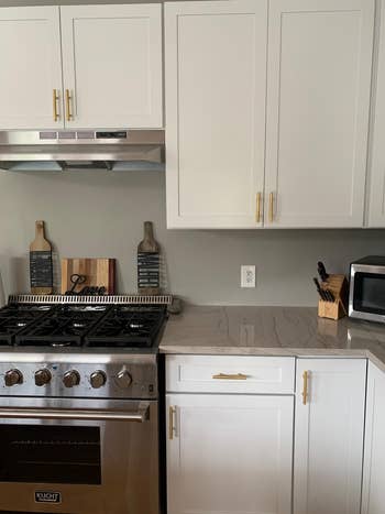 reviewer's gold brass pulls installed on kitchen cabinets
