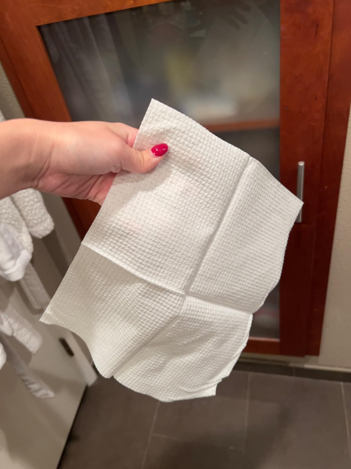Person holding a azygous  achromatic  look   towel successful  a bathroom