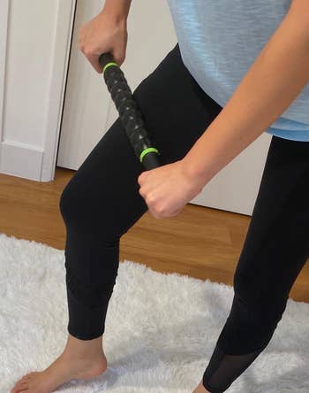 reviewer using the same muscle roller stick on their upper thigh