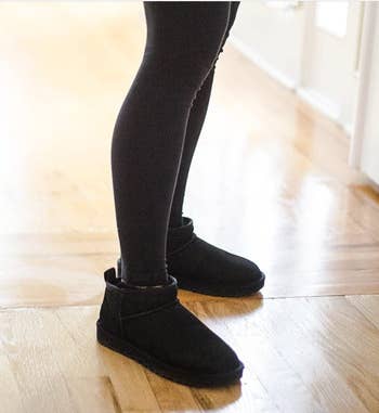 Reviewer in black soft ankle booties 