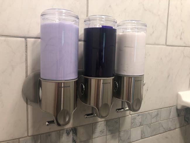 Three ablution pump dispensers connected a ablution wall