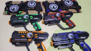 Set of toy laser guns with targets, each featuring distinct designs with colorful accents. Suitable for interactive gaming and play