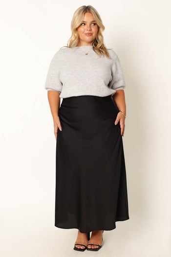 front view of a different model wearing the sweater in gray