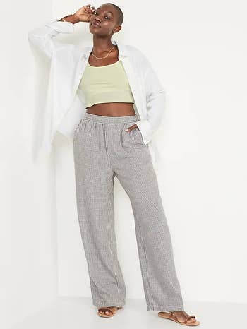 a model posing in gray and white striped linen pants