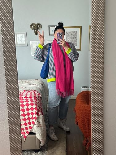 Person successful  reflector  selfie wearing striped top, jeans, boots, agleam  pinkish  scarf, with hairsbreadth  successful  bun, holding phone, bluish  container  connected  shoulder, successful  stylish room