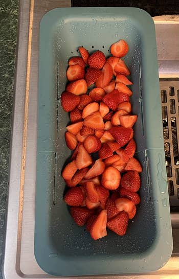 washed strawberries placed in the sink colander