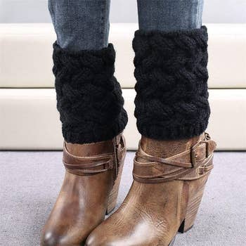 model wearing the black boot cuffs over a pair of tan boots
