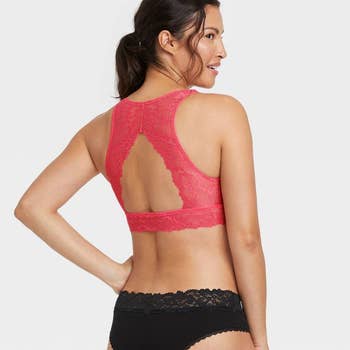 back of a model wearing the pink lace bralette and black lace panties
