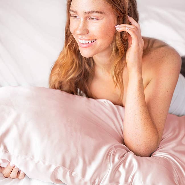 Model laying on the pink pillowcase 