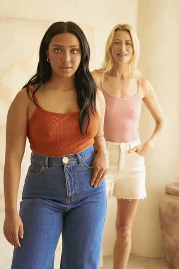 two other models wearing the bodysuit paired with jeans and white shorts