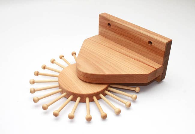 Wooden mount with 24 pegs that spin