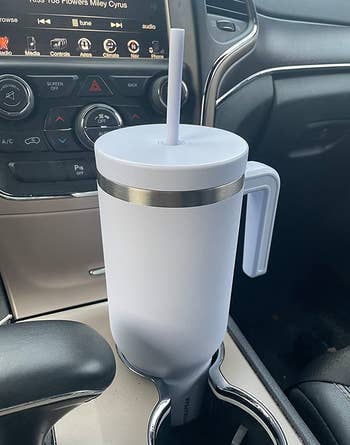 reviewer photo of the white tumbler in a car cupholder