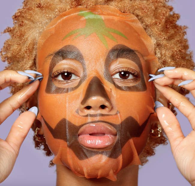 A idiosyncratic wearing a Halloween-themed look disguise adjusts it portion looking into the camera, highlighting a quality merchandise for skincare