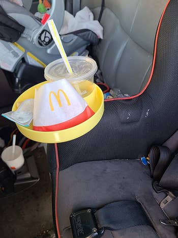 The tray successful  a carseat cupholder filled with takeout nutrient  from McDonald's
