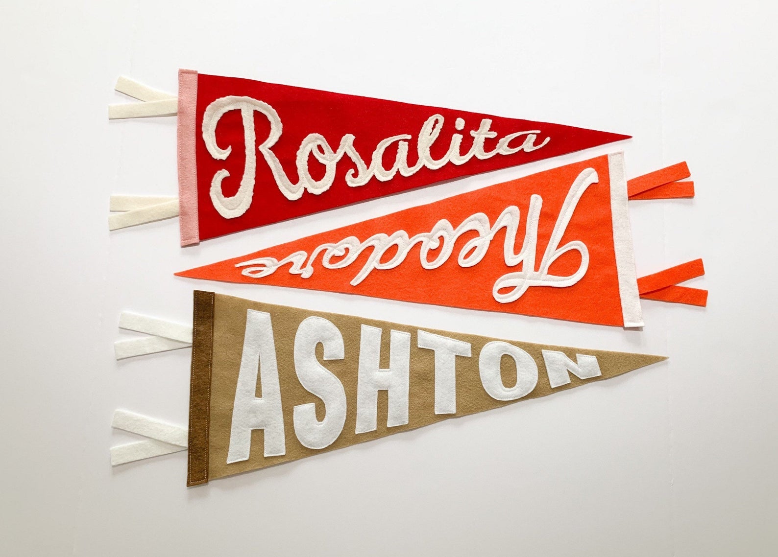 three pennants customized to say Rosalita, Theodore, and Ashton
