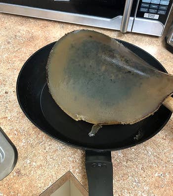 a reviewer photo of the solidified cooking oil in a pan 