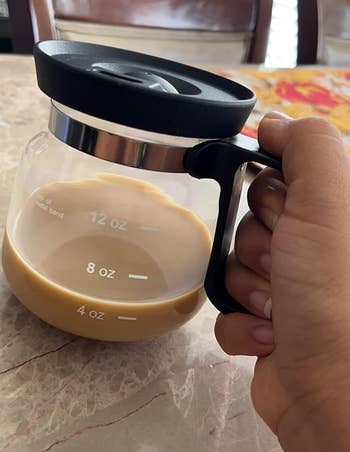 reviewer holding coffee mug