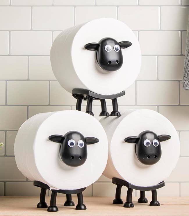 Three toilet insubstantial rolls connected sheep-shaped holders