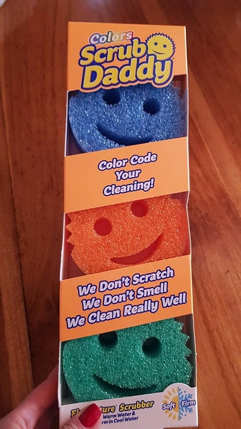 A three-pack of blue, orange, and green Scrub Daddy sponges