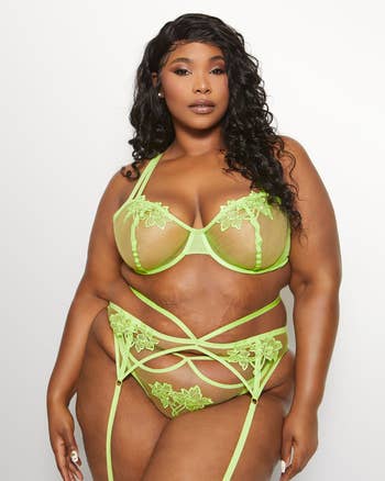 model wearing lime green garter belt with matching bra and panty set