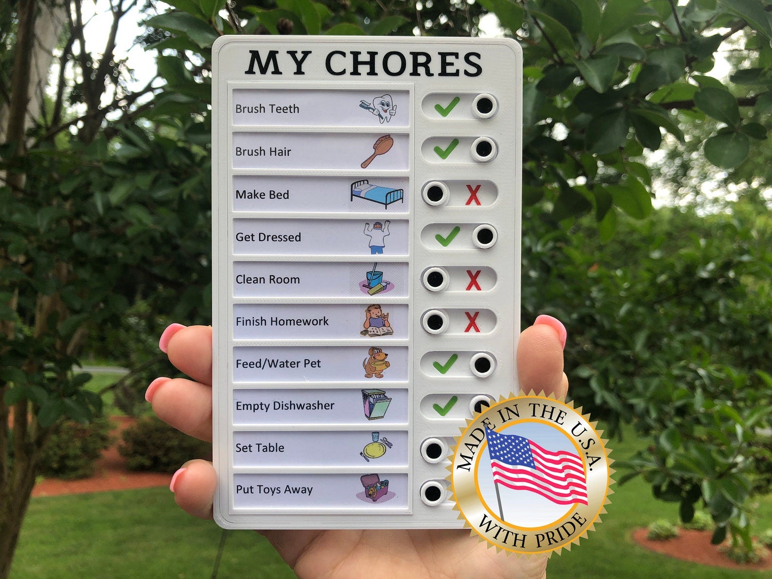 Model holding small rectangular list of chores with toggles indicating if they're been completed or not 