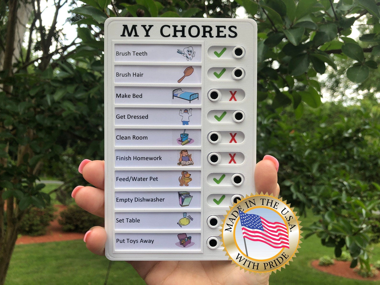 Model holding small rectangular list of chores with toggles indicating if they're been completed or not