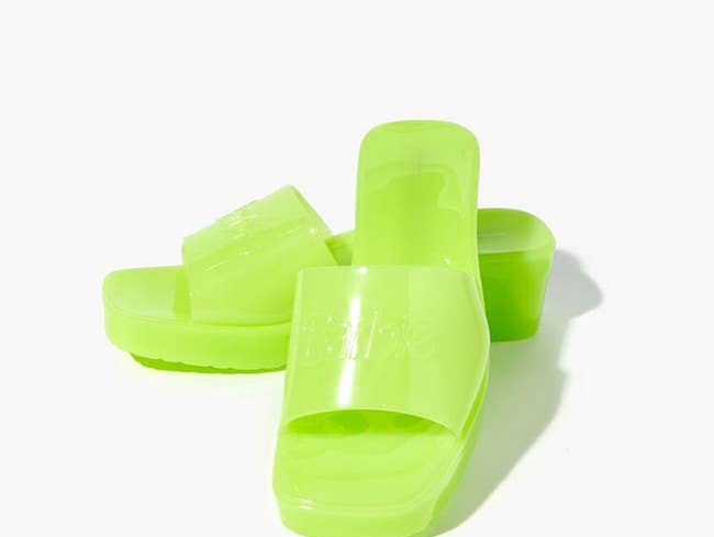 neon green jelly block heels with the barbie logo on them