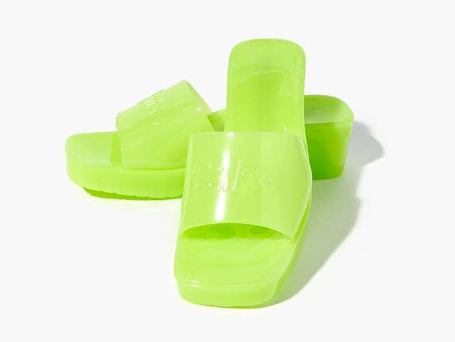 neon green jelly block heels with the barbie logo on them