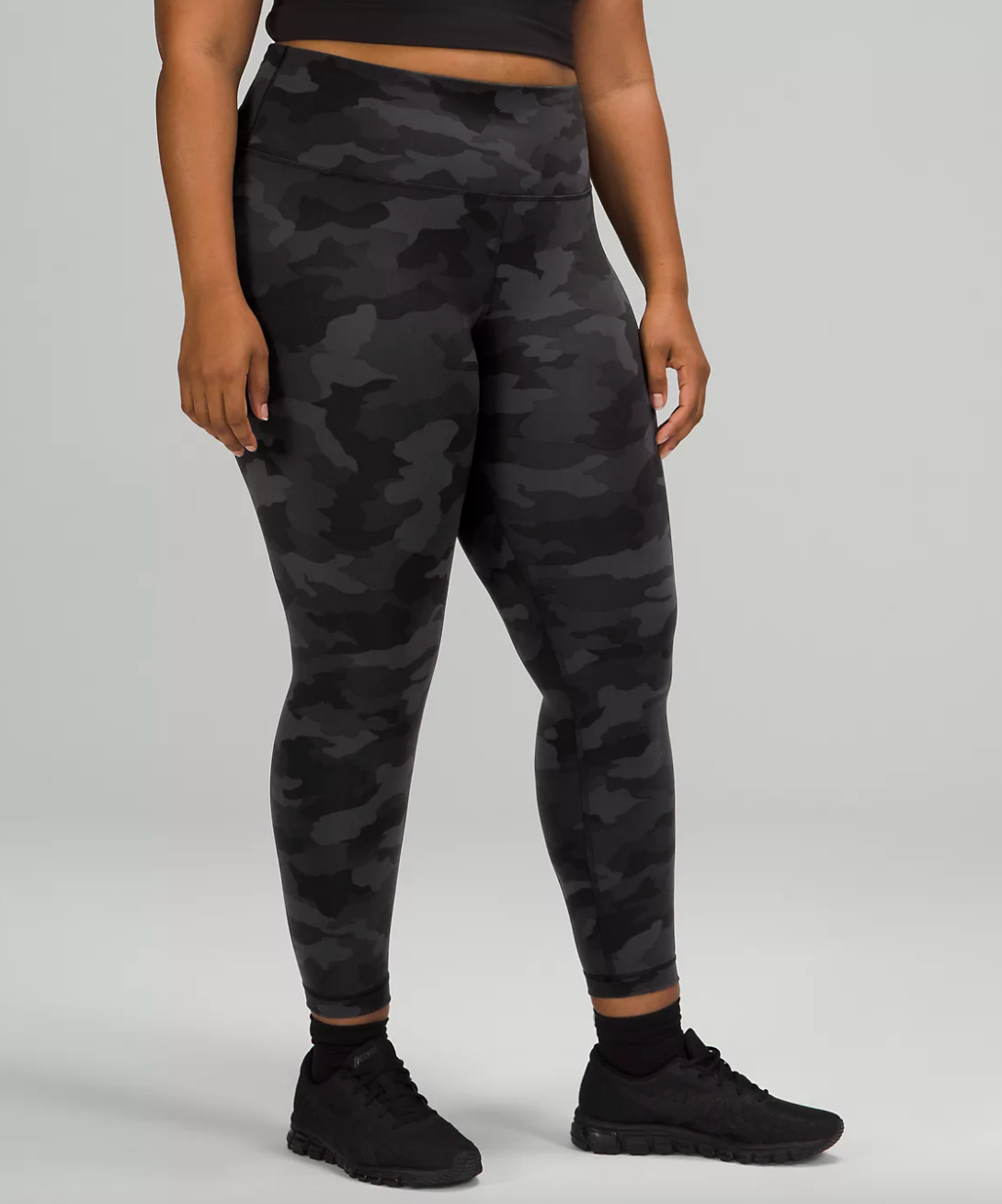 model wearing the full-length leggings in black and grey camo print