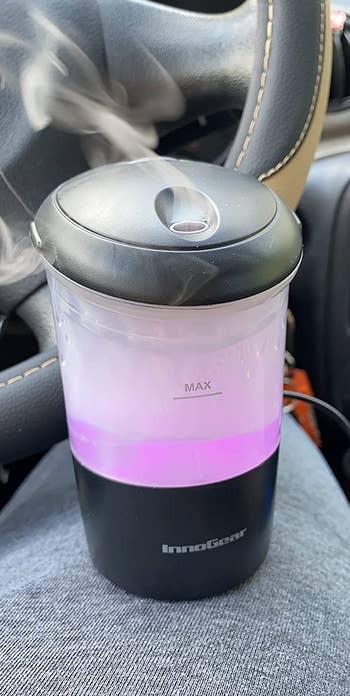 a reviewer photo of diffuser with the base illuminated purple 