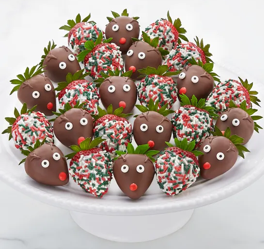 santa's reindeer chocolate dipped strawberries on a plate