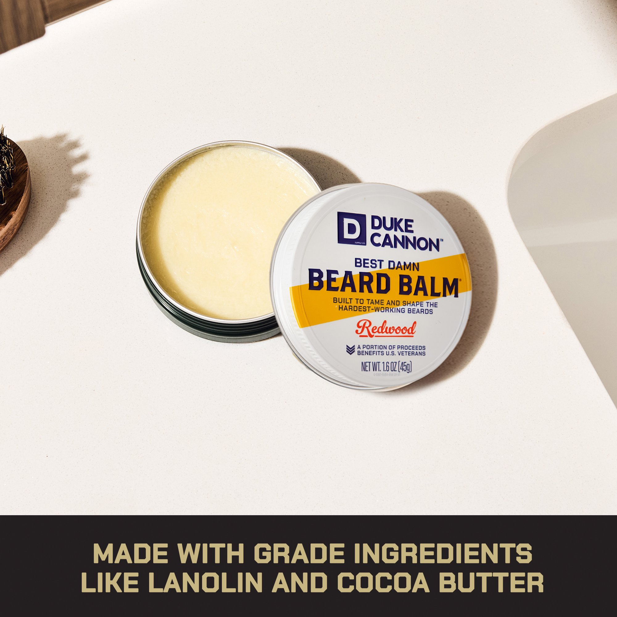 Duke Cannon Best Damn Beard Balm successful  a tin, positioned connected  a bath  counter. 