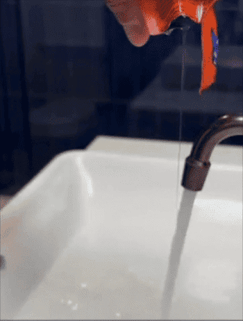 Hand holding a snack pack, adding pulverization  to h2o  successful  sink; imaginable   merchandise  for location  use