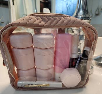 Clear question toiletry container with immoderate of the pinkish capsules inside