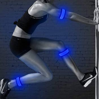 model wearing blue led armbands on their biceps and ankles