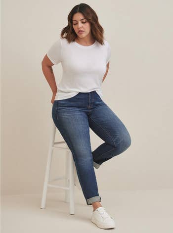 model wearing dark blue denim jeans