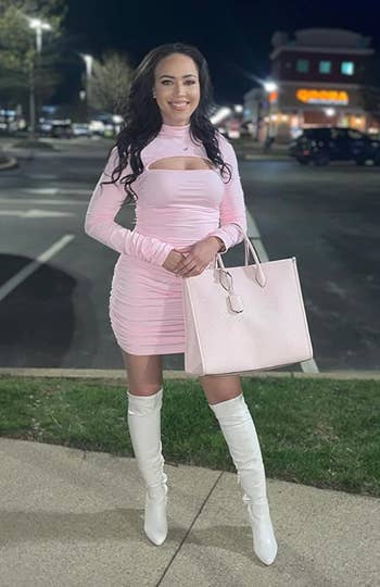 reviewer posing, smiling in light pink dress