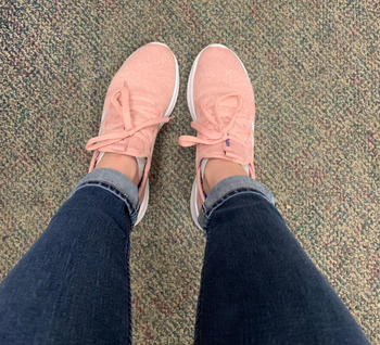 reviewer wearing the sneakers in pink