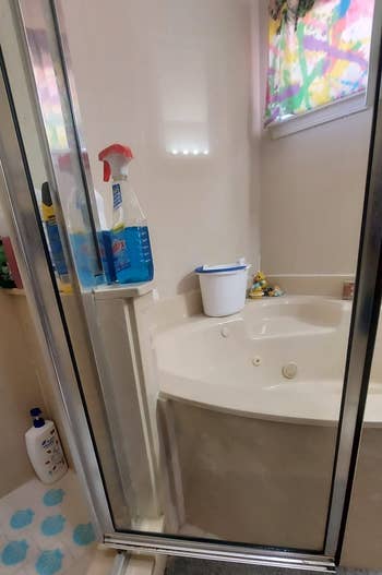 Reviewer photo of same shower door after cleaning with Rain-X cleaner