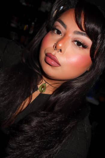 Person with agelong  hairsbreadth  and a chemoreceptor  ringing  wearing a necklace with a greenish  pendant, posing for a close-up photo