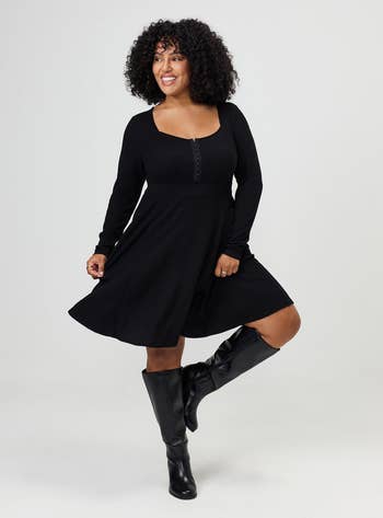 Person successful  a stylish knee-length formal  with agelong  sleeves and knee-high boots poses confidently, suitable for buying  and evening outings