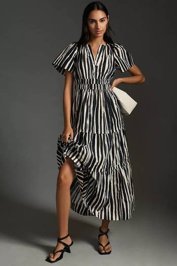 model wearing the dress in black and white stripes