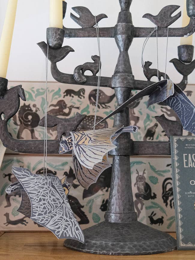 Metal candelabra with hanging decorative insubstantial  food  ornaments displayed successful  a location  interior setup