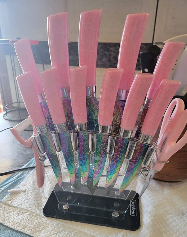 A set of pink handled knives with rainbow iridescent blandes 