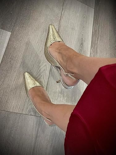 Person wearing stylish pointed-toe precocious   heels successful  a textured pattern, paired with a reddish  skirt, lasting  connected  a woody  floor