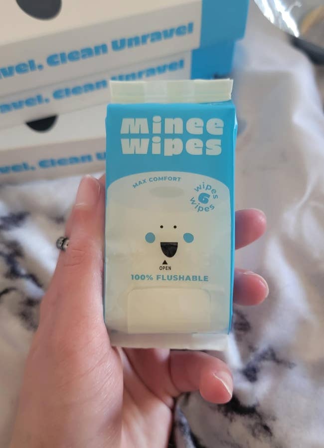 reviewer holding pack of wipes